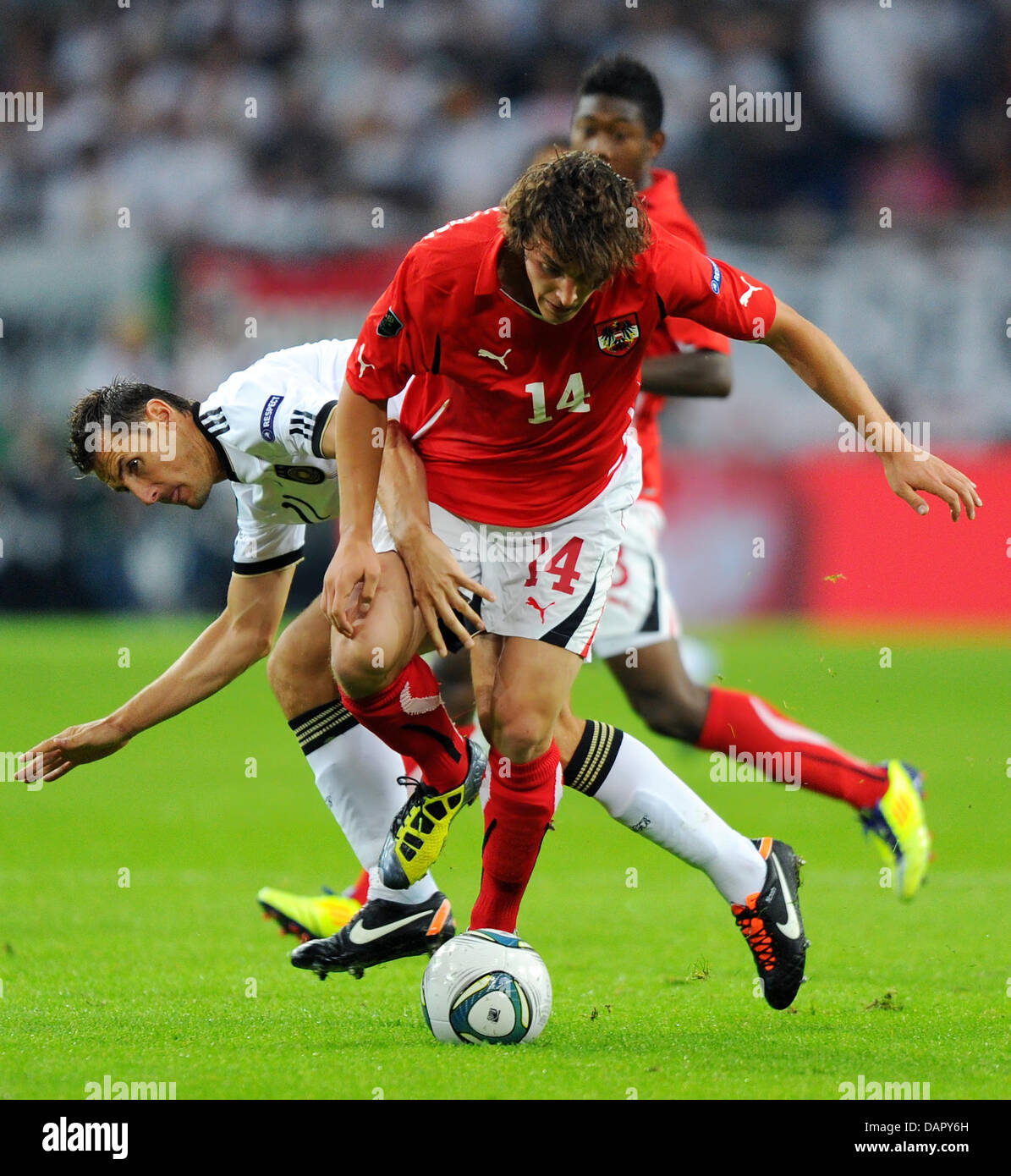 Germany's Miroslav Klose (BACK) vies for the ball with Austria's Julian Baumgartlinger  during the EURO 2012 group A qualifier match Germany vs Austria at Arena Auf Schalke in Gelsenkirchen, Germany, 02 September 2011. Photo: Thomas Eisenhuth Stock Photo