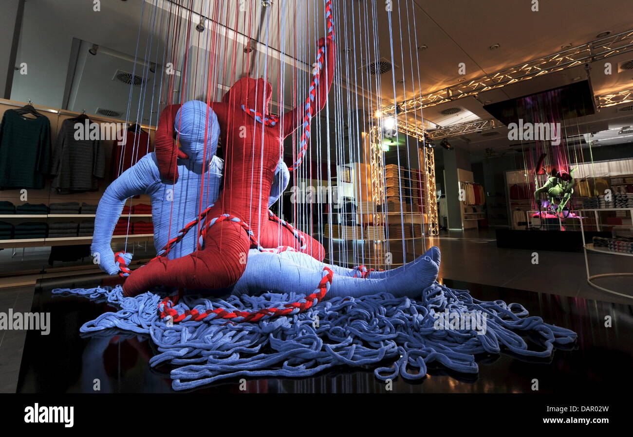 A sculpture of the 'Lanasutra' installation stands in a store of the fashion company Benetton in the Kaufingerstrasse in Munich, Germany, 06 September 2011. 15 sculptures in total by the Cuban artist Erik Ravelo, which show lovers in kamasutra poses and which are wrapped with wool, will be exhibited in Beneton stores in Munich, Milan and Istanbul. The name 'Lanasutra' comes from th Stock Photo