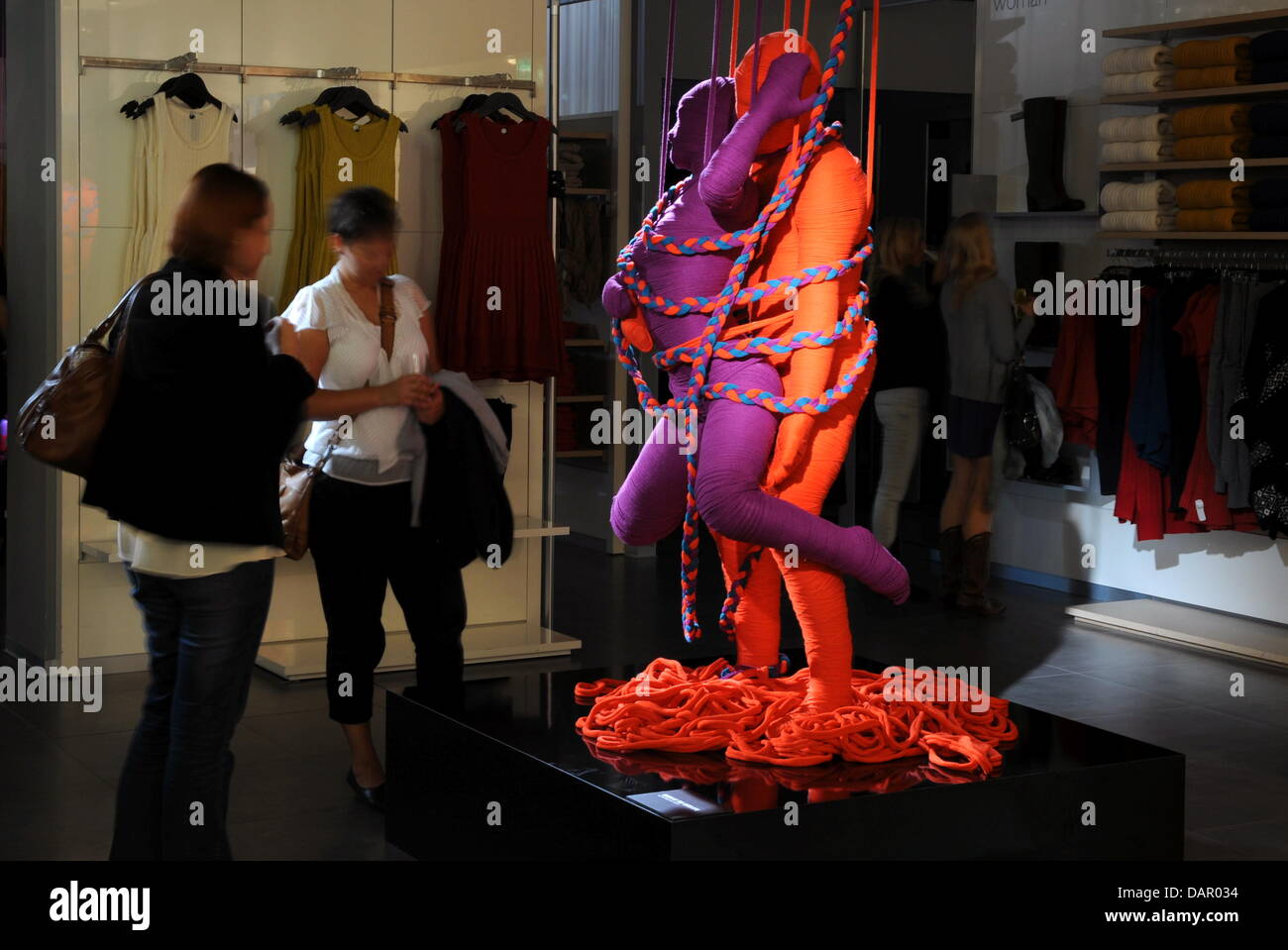 A sculpture of the 'Lanasutra' installation stands in a store of the fashion company Benetton in the Kaufingerstrasse in Munich, Germany, 06 September 2011. 15 sculptures in total by the Cuban artist Erik Ravelo, which show lovers in kamasutra poses and which are wrapped with wool, will be exhibited in Beneton stores in Munich, Milan and Istanbul. The name 'Lanasutra' comes from th Stock Photo