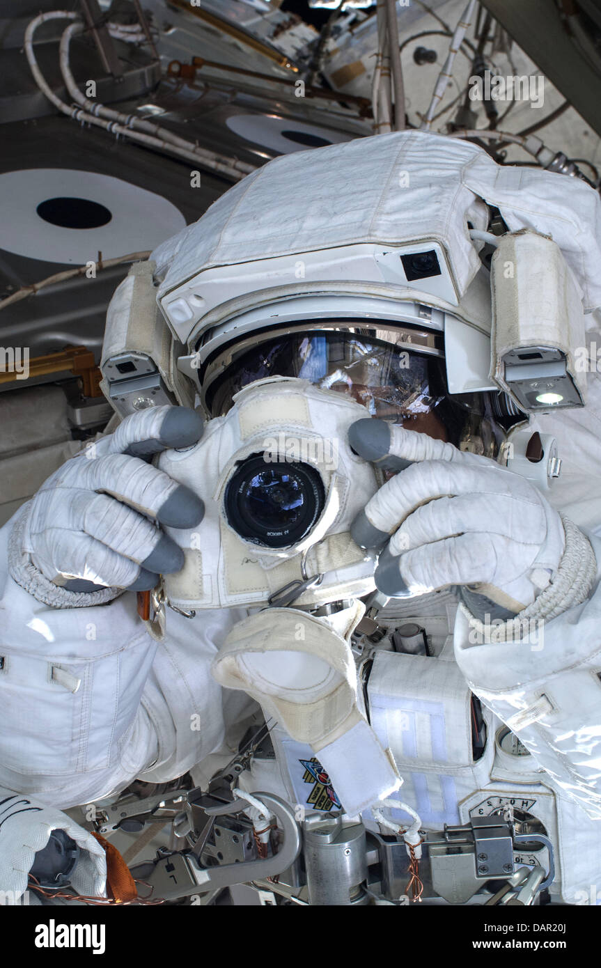 European Space Agency astronaut Luca Parmitano takes a photo during a space walk outside the International Space Station July 16, 2013. A little more than one hour into the spacewalk, Parmitano reported water floating behind his head inside his helmet. The water was not an immediate health hazard for Parmitano but Mission Control decided to end the spacewalk early. Stock Photo