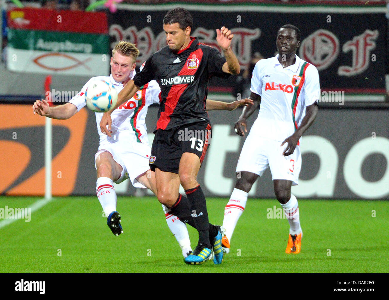 Leverkusen's Michael Ballack vies for the ball with Augsburg's Jan-Ingwer Callsen-Bracker (L) jersey during the German Bundesliga match between FC Augsburg and Bayer Leverkusen at the SGL Arena in Ausgburg, Germany, 09 September 2011. Photo: STEFAN PUCHNER  (ATTENTION: EMBARGO CONDITIONS! The DFL permits the further utilisation of the pictures in IPTV, mobile services and other new Stock Photo
