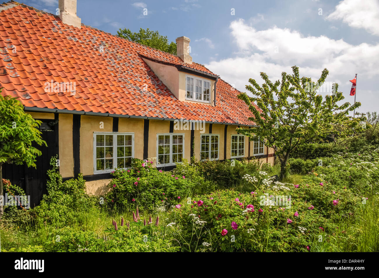 Country house with green garden in Melsted on Bornholm, Denmark Stock Photo