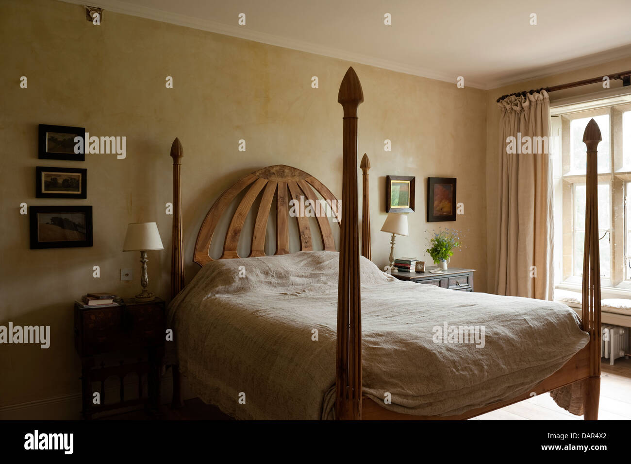 Carved headboard of four poster bed in Gloucestershire country estate