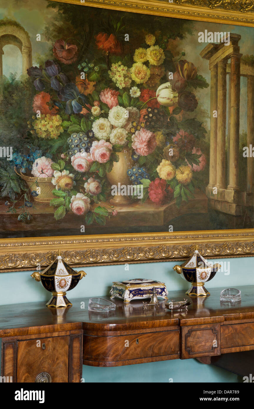 Still-life painting of flowers above antique console table in Ampney Park, 17th century English country house Stock Photo