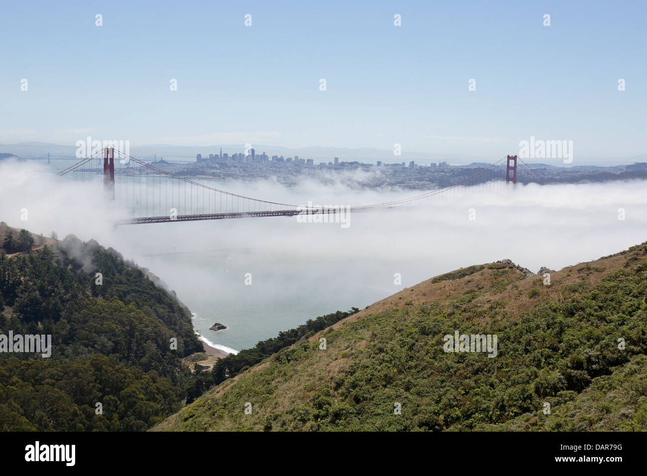 View of the Golden Gate Bridge bathed in fog from Hawk Hill with San Francisco in the background Stock Photo