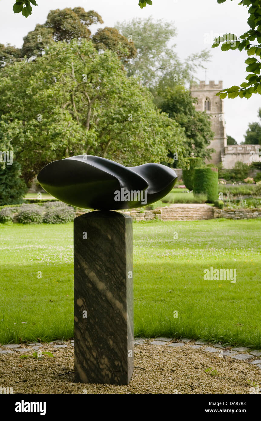 Granite sculpture by Johnny Turner in the 17th century grounds of manor house, Ampney Park Stock Photo