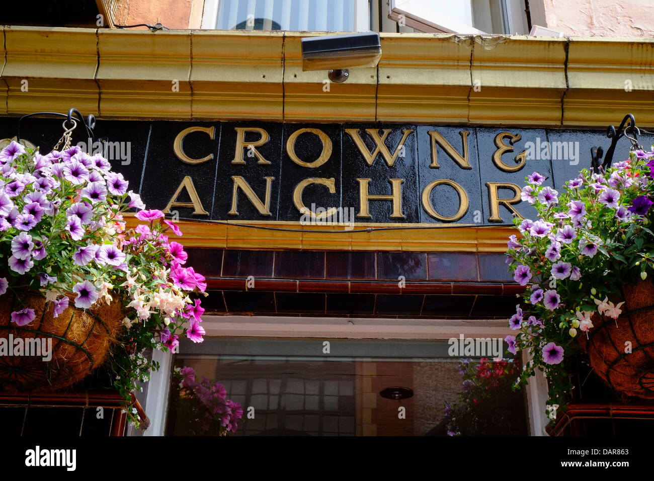 England, Manchester, hanging baskets outside the Crown & Anchor Public house Stock Photo