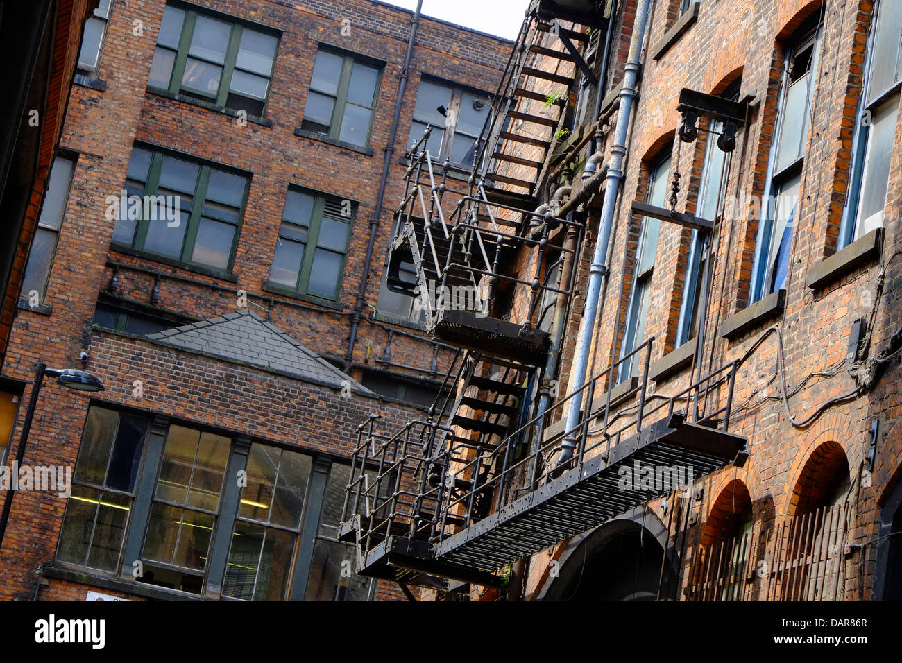 England, Manchester, cast iron fire escape on old mill building Stock