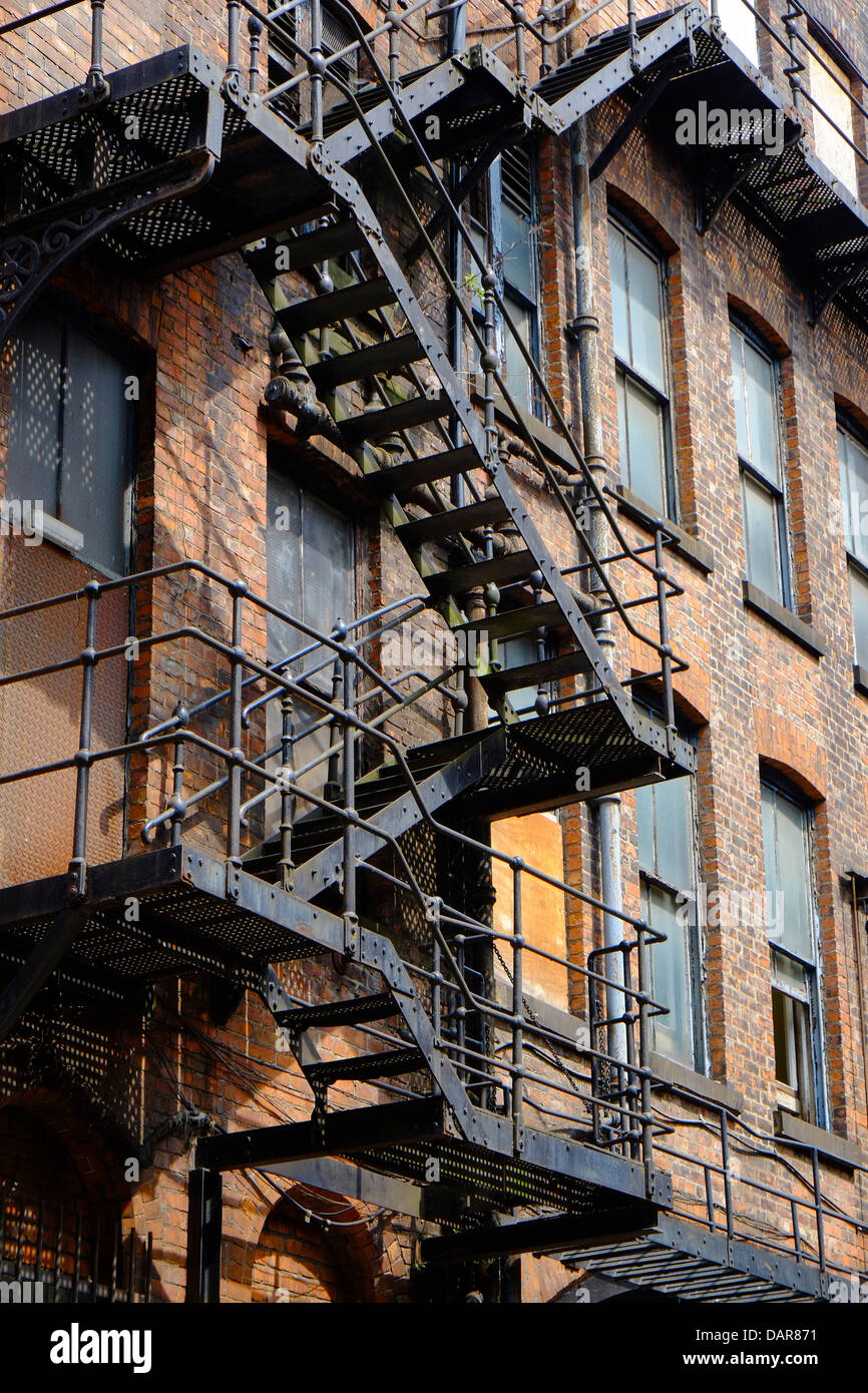 England, Manchester, cast iron fire escape on old mill building Stock