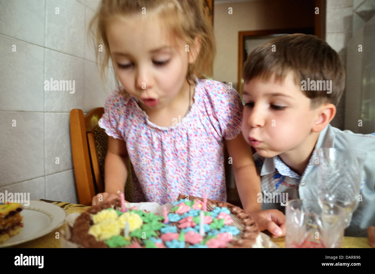 Brother sister blowing birthday candles hires stock photography and