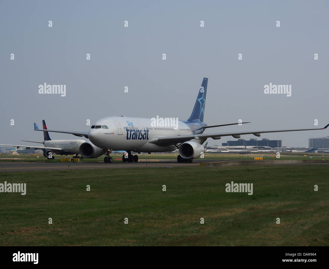 The Air Transat Airbus A330-243, registration C-GTSN, is seen at Schiphol Airport. This wide-body aircraft is used for long-haul international flights, providing comfort and efficiency for passengers. Stock Photo