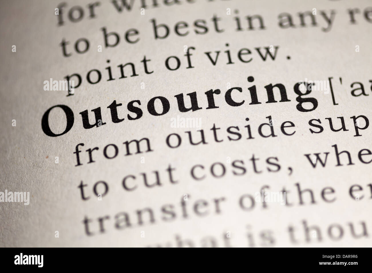 Fake Dictionary, Dictionary definition of the word Outsourcing. Stock Photo