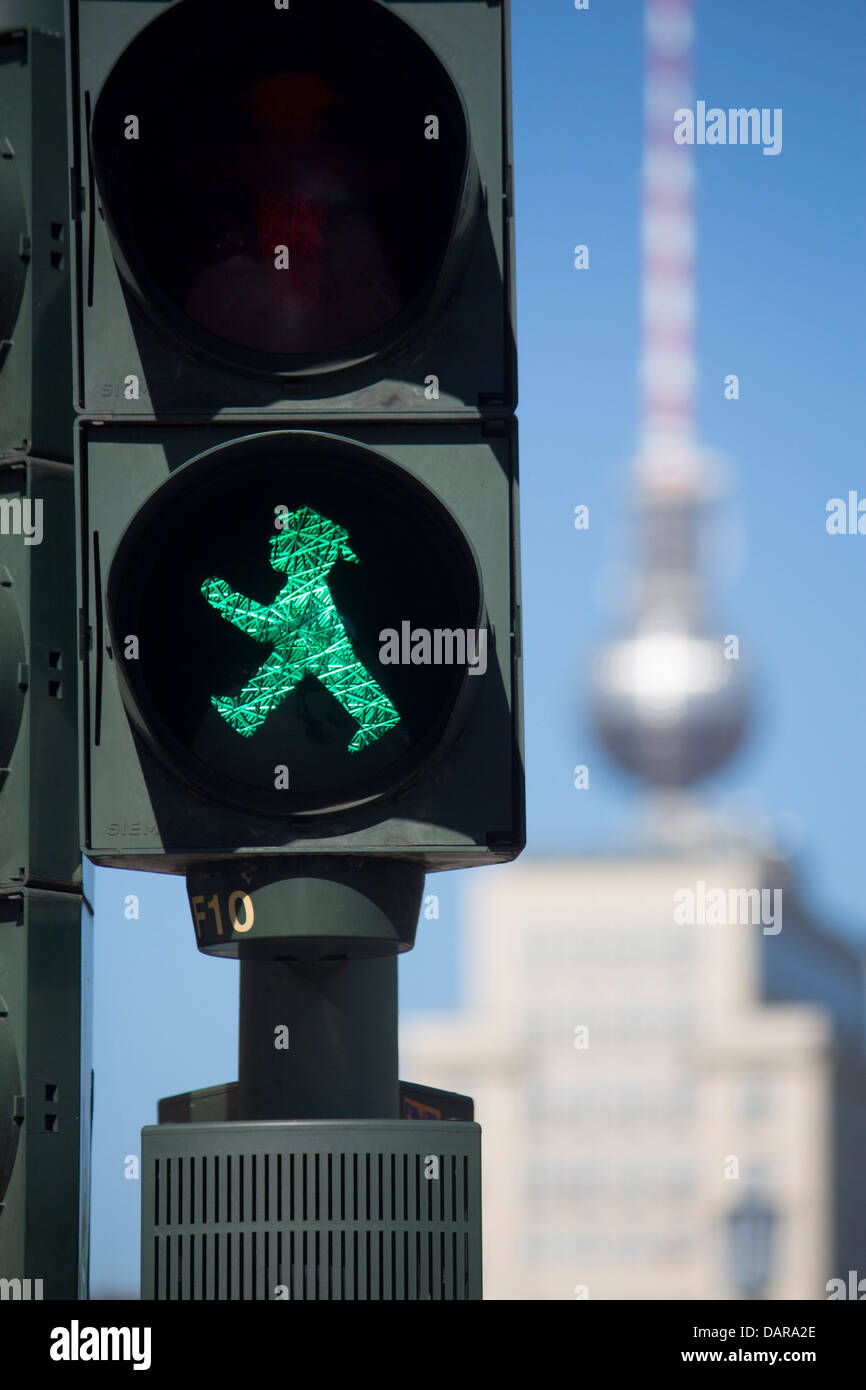 GDR era traffic light pedestrian signal little green man with Fernsehturm TV Tower in distance Berlin Germany Stock Photo