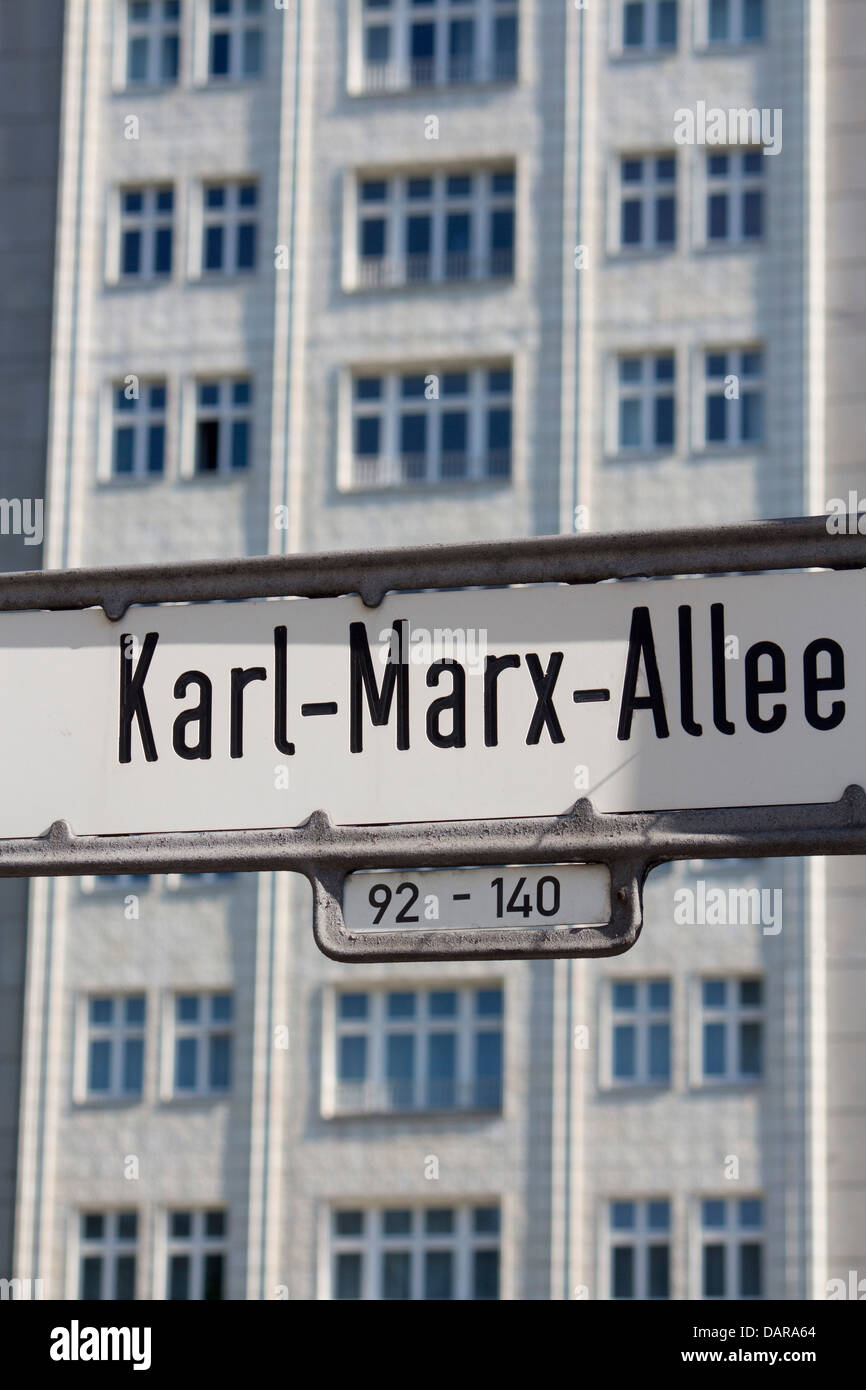 Karl Marx Allee sign with distinctive Socialist Realist buildings behind Friedrichshain Berlin Germany Stock Photo