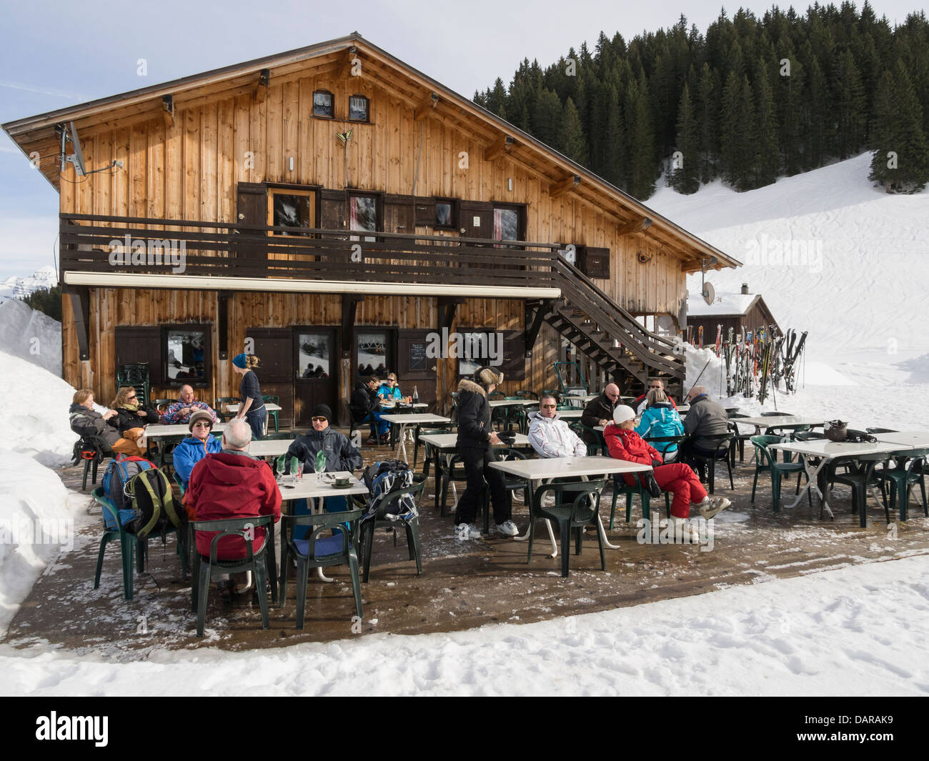 People dining outside Gite du Lac de Gers alpine lakeside ski chalet restaurant in Le Grand Massif in French Alps. Sixt Samoens Haute Savoie France Stock Photo