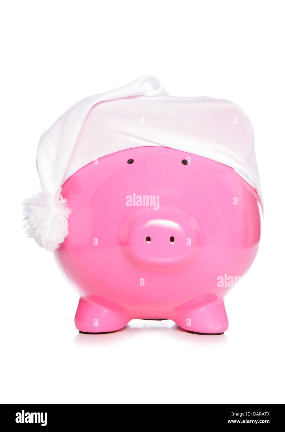 Piggy bank wearing sleeping cap studio cutout Stock Photo