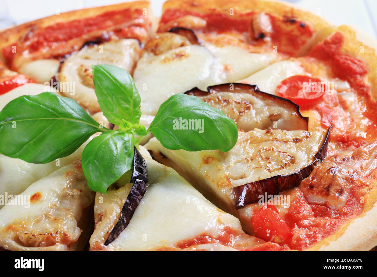 Pizza topped with cheese and slices of eggplant Stock Photo