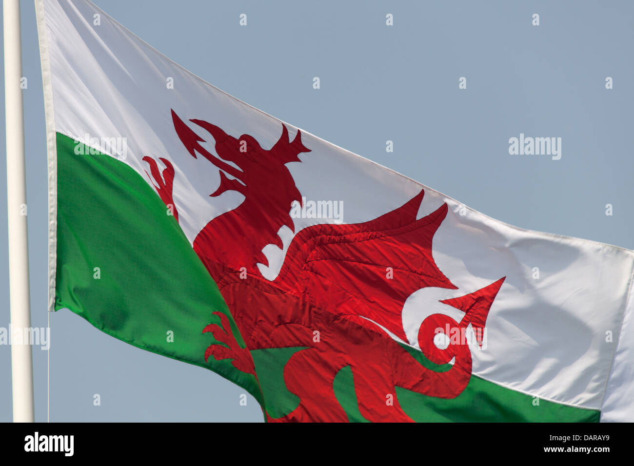 Town of Harlech, Wales.  Close up view of the Red Dragon Welsh flag flying over Harlech Castle gatehouse. Stock Photo
