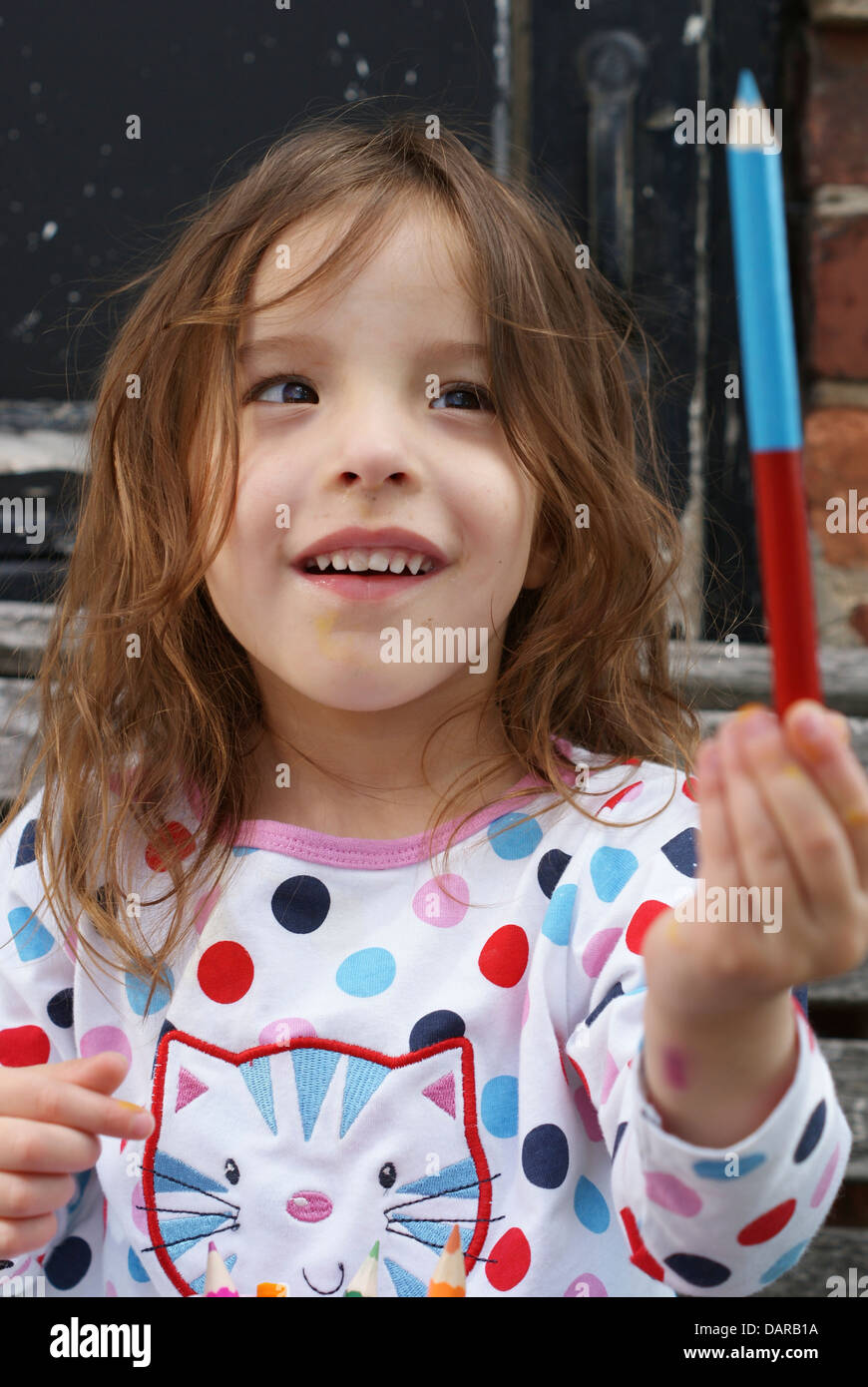 Girl couloring outside in pyjamas Stock Photo