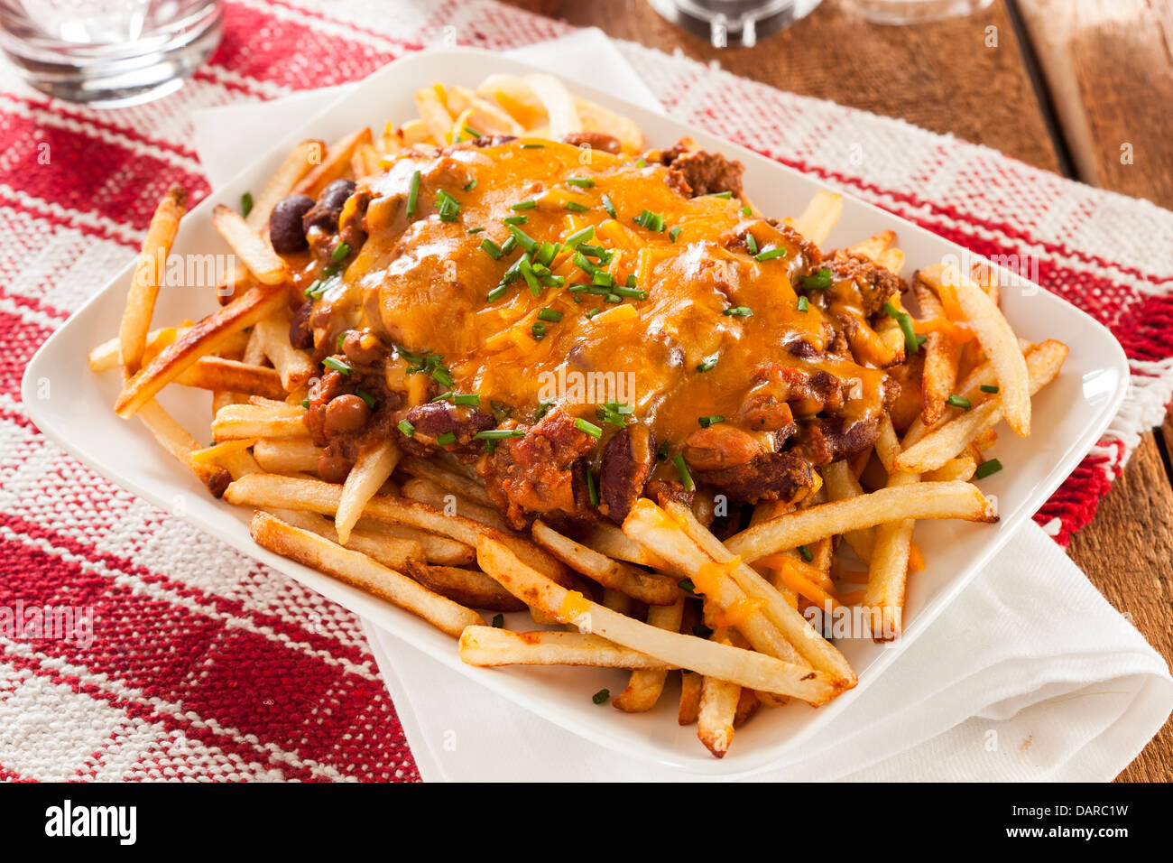 Unhealthy Messy Chili Cheese Fries on a Background Stock Photo