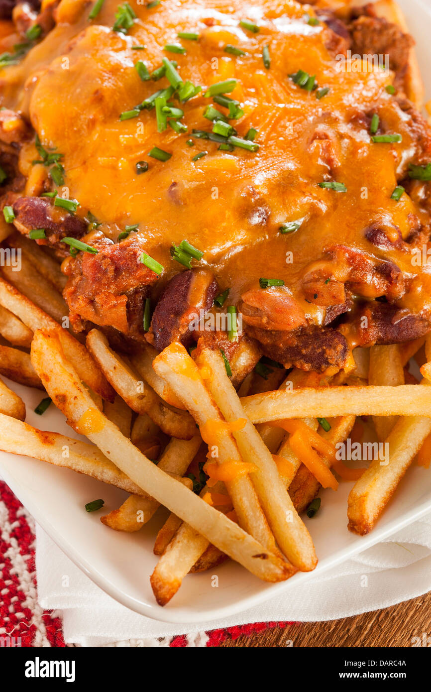 Unhealthy Messy Chili Cheese Fries on a Background Stock Photo