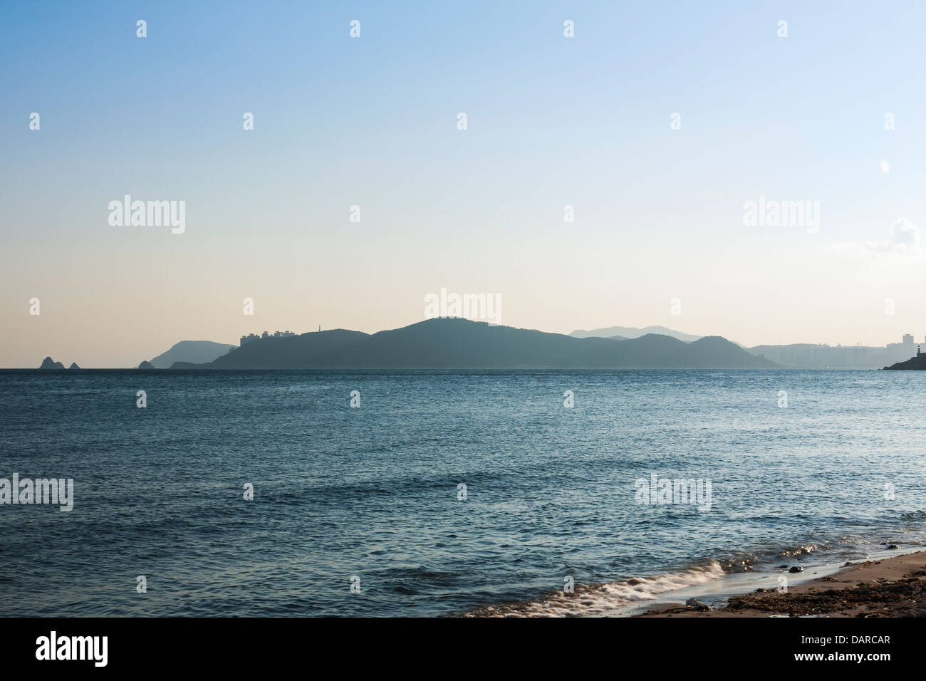 View from Haeundae Beach in Busan towards Nam-gu in Southern Busan and Oryukdo islands during sunset on a windy evening. Stock Photo