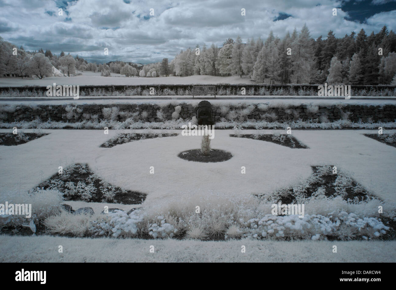 Horizontal Infrared image of gardens in front of Balmoral Castle, Royal Deeside, Scotland, UK with trees and clouds. Stock Photo