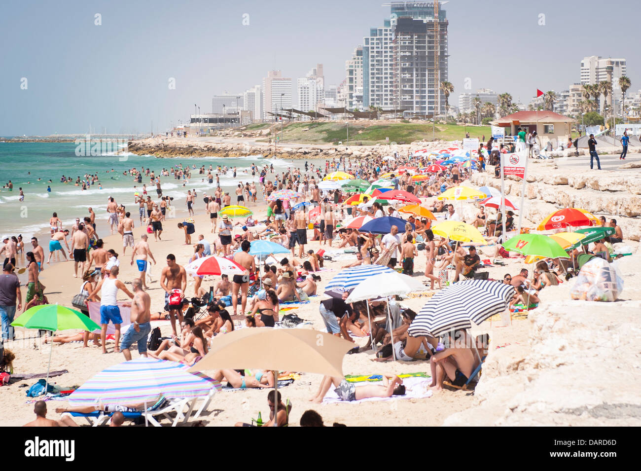 Israel Tel Aviv Jaffa Yafo Manta Ray Beach crowds under parasols umbrellas sonnenschirm sand sea sunbathers sunbathers Stock Photo