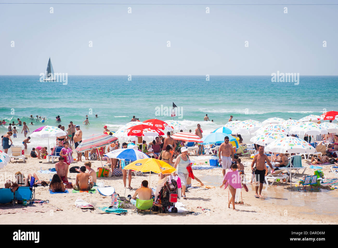 Israel Tel Aviv Jaffa Yafo Manta Ray Beach crowds under parasols umbrellas sonnenschirm sand sea sunbathers sunbathers Stock Photo