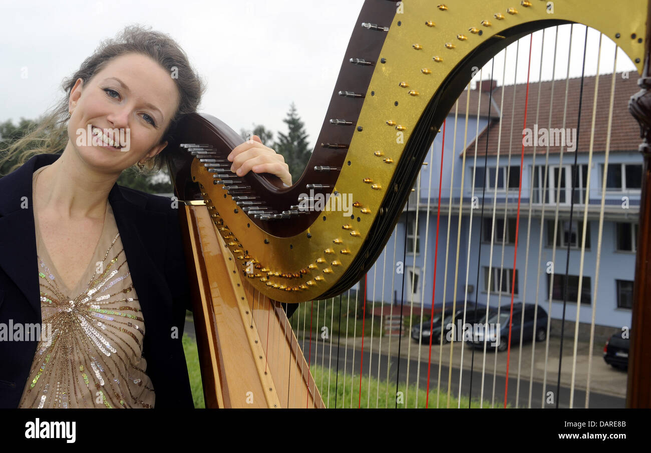 Harp player Assia Cunego from Italy poses with one of her valuable