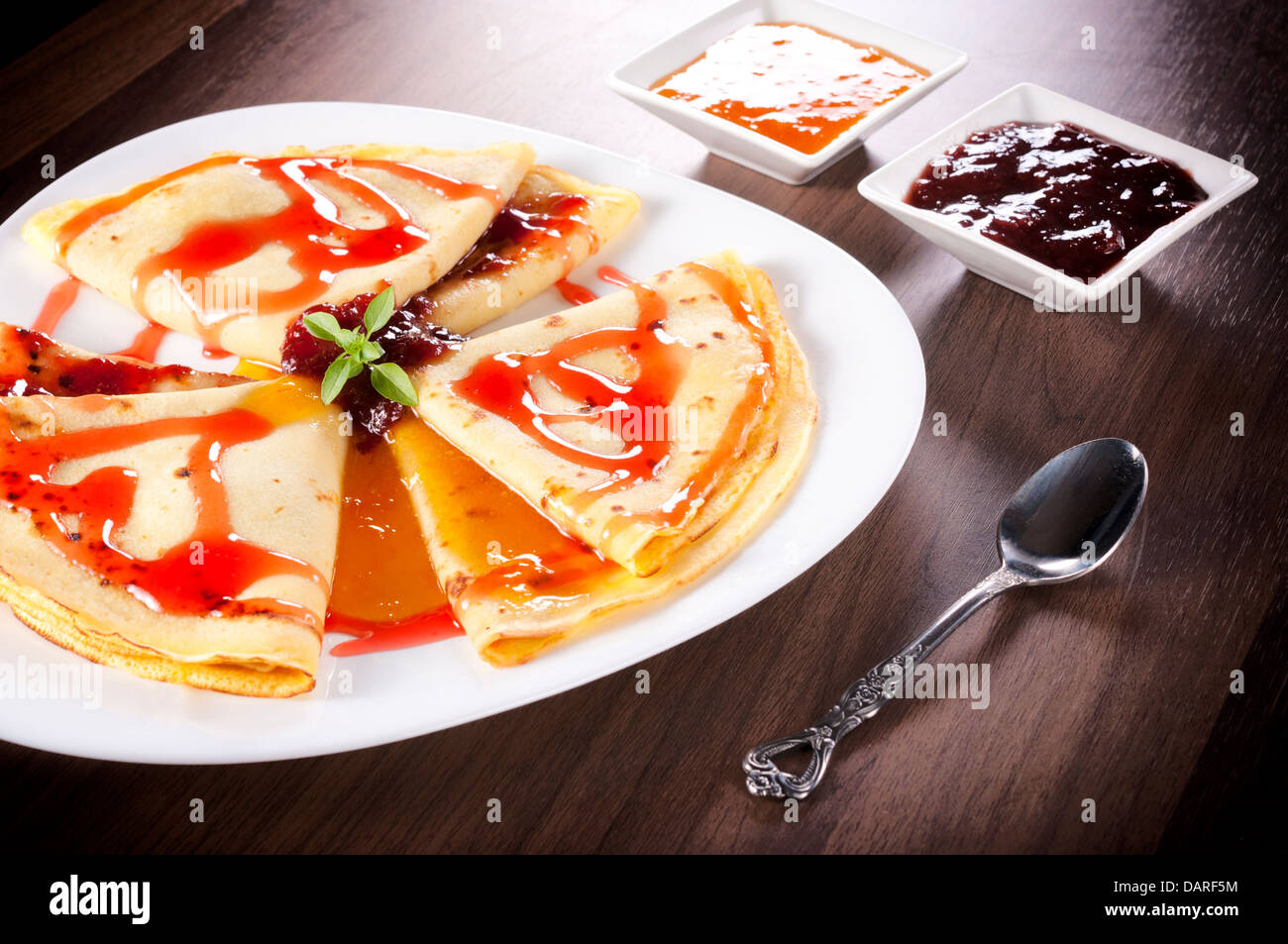 Apricot and strawberries jam on the homemade pancakes Stock Photo