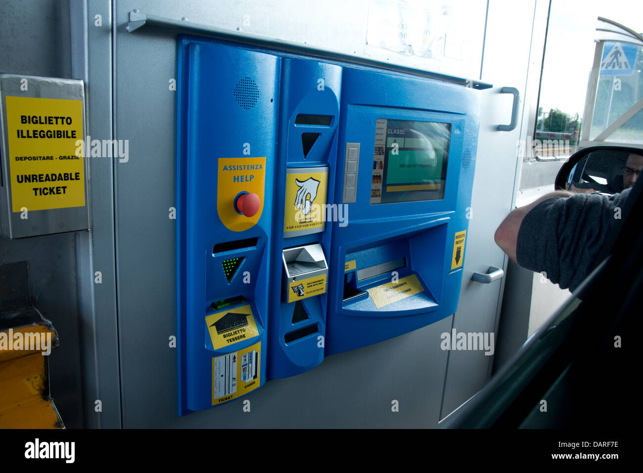 Driver at blue Italian toll-booth machine on autostrada in ...