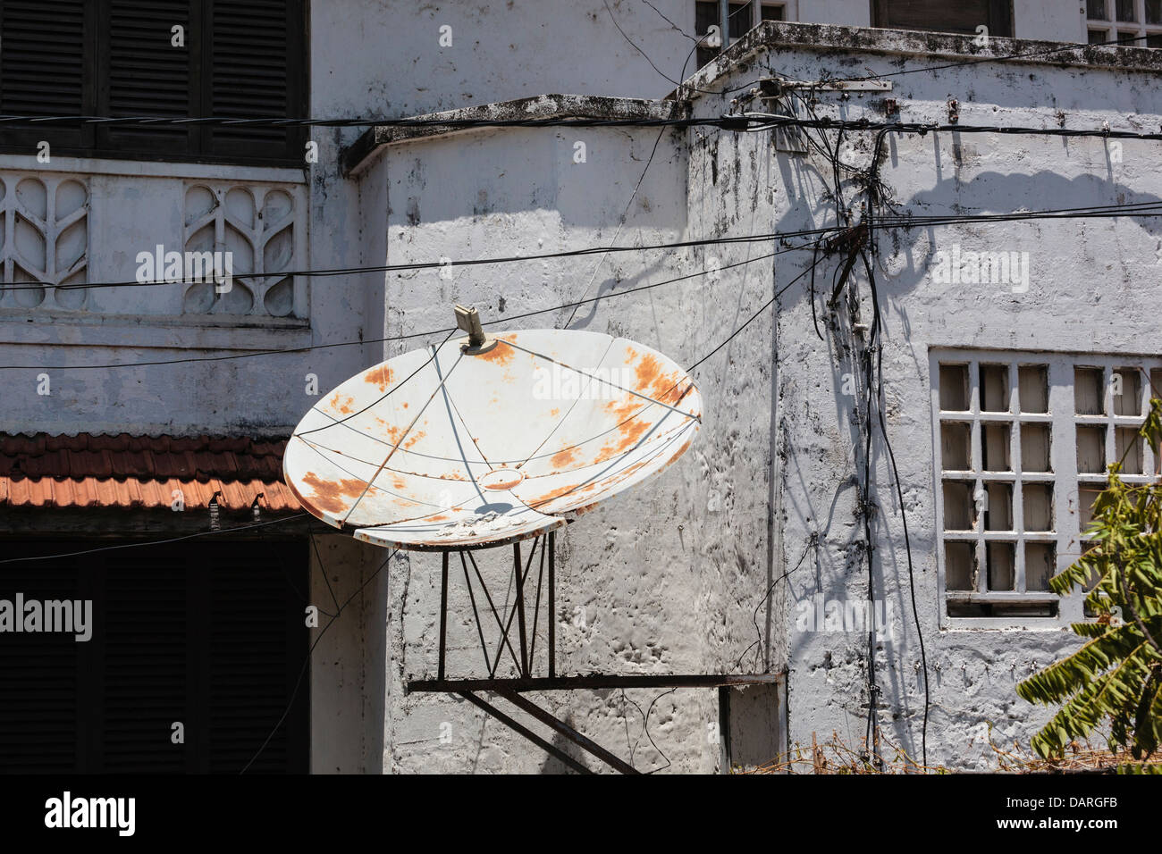 Africa, Tanzania, Zanzibar, Stone Town. Satellite dish on historic building. Stock Photo