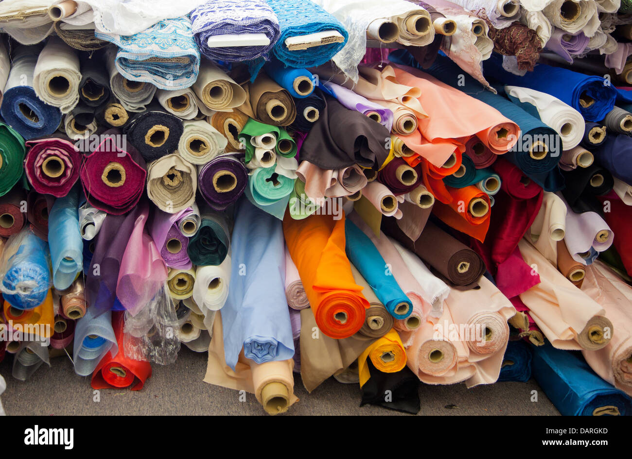 A background of rolls of various colored fabric Stock Photo