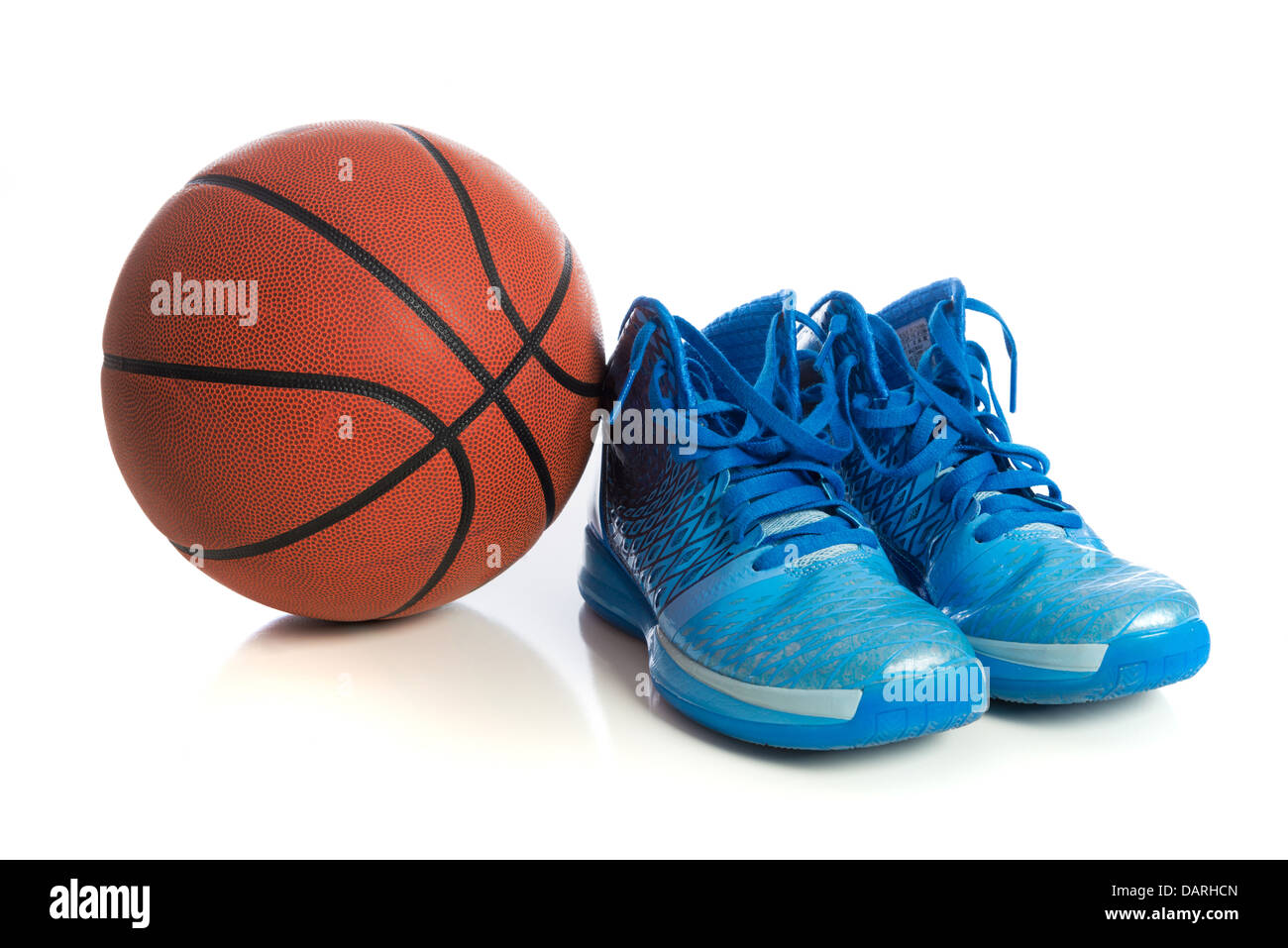 A basketball with blue high tops on a white background Stock Photo