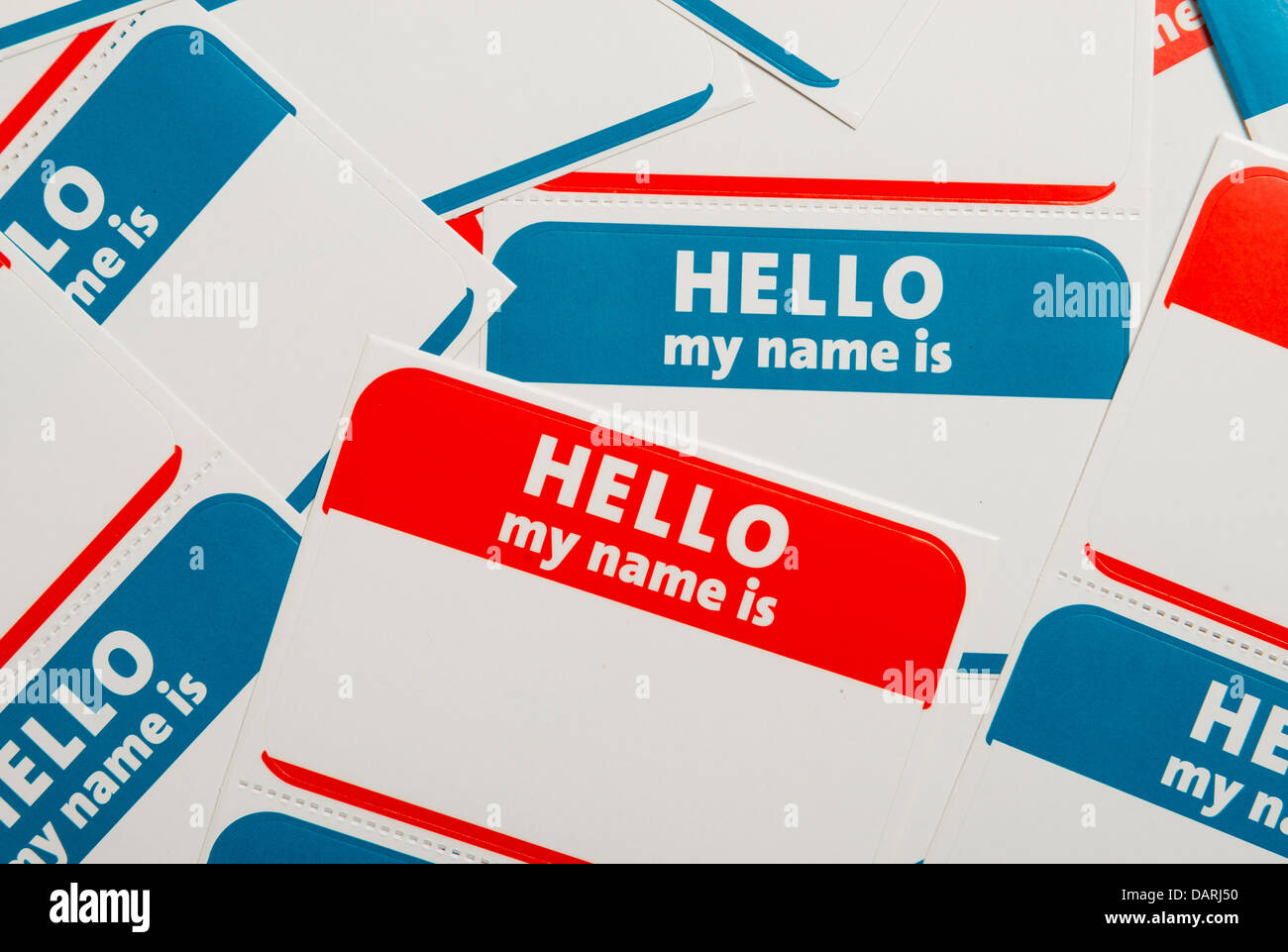 A stack of blue and red 'Hello, my name is' name tags or badges Stock Photo