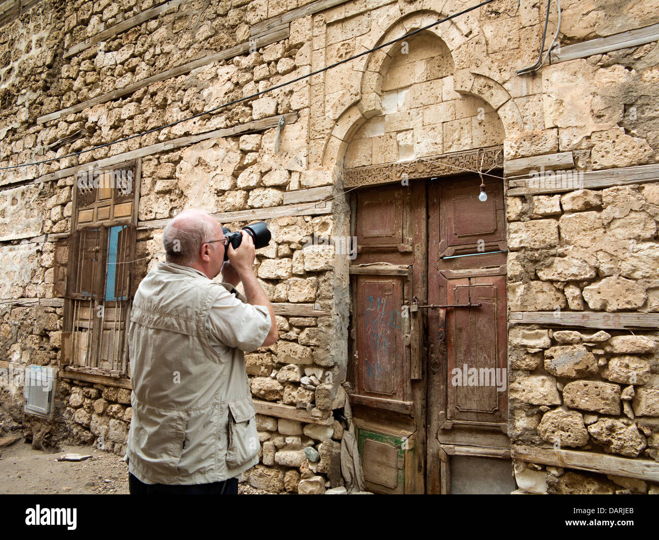 Africa, Eritrea, Massawa, Old Town, tourist photographing carved lintel of Ottoman style arched doorway Stock Photo