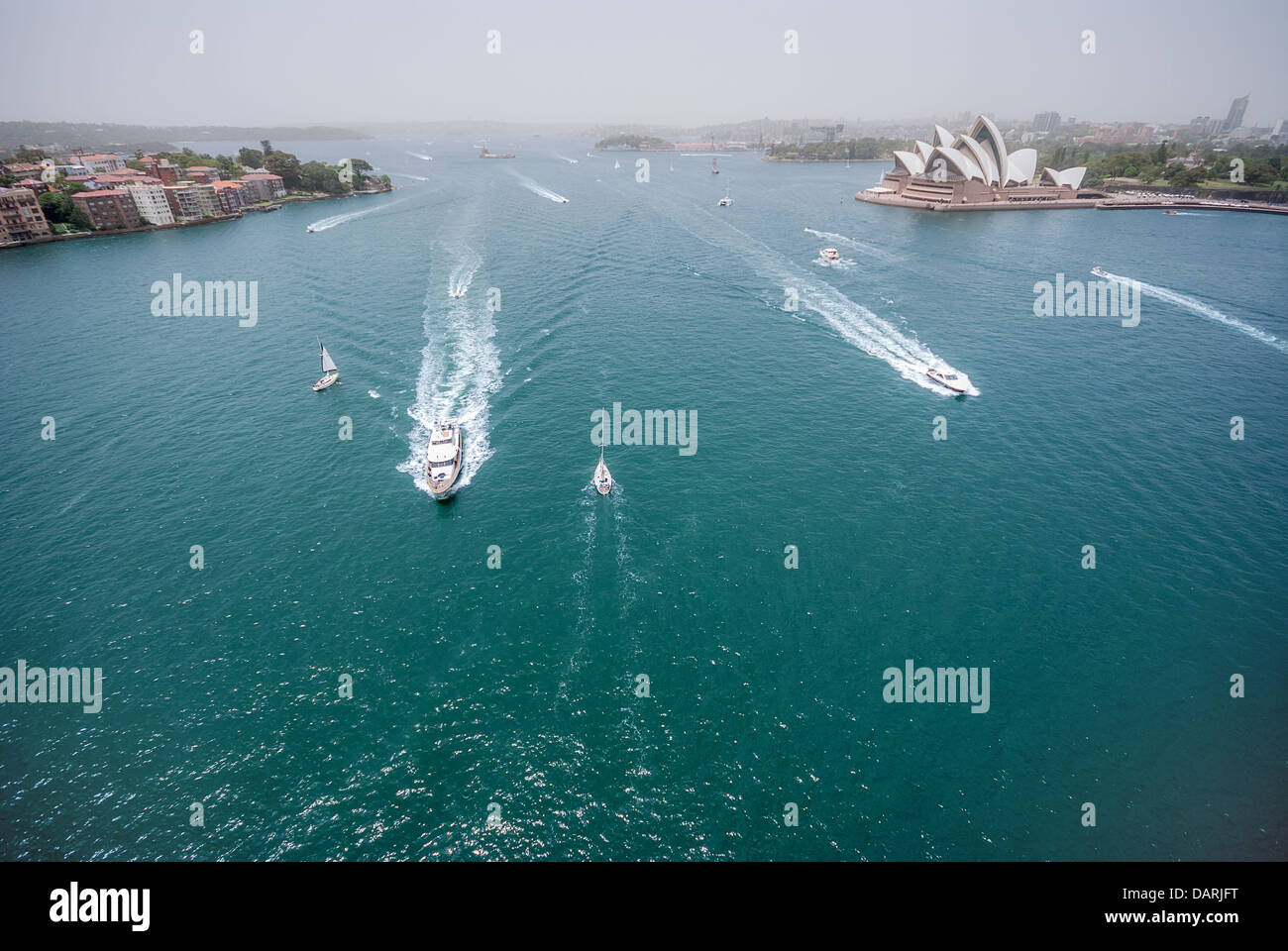 Ferries pass by the majestic Sydney Opera House in busy Sydney Harbour. Stock Photo