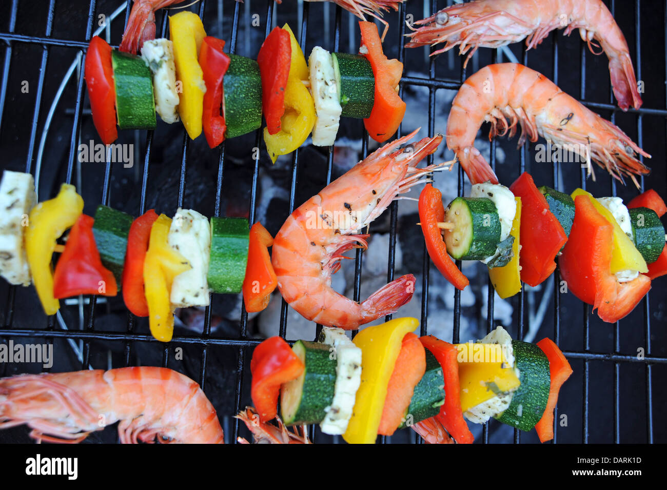 Large Madagascan prawns chargrilled cooking on a barbecue or bbq with