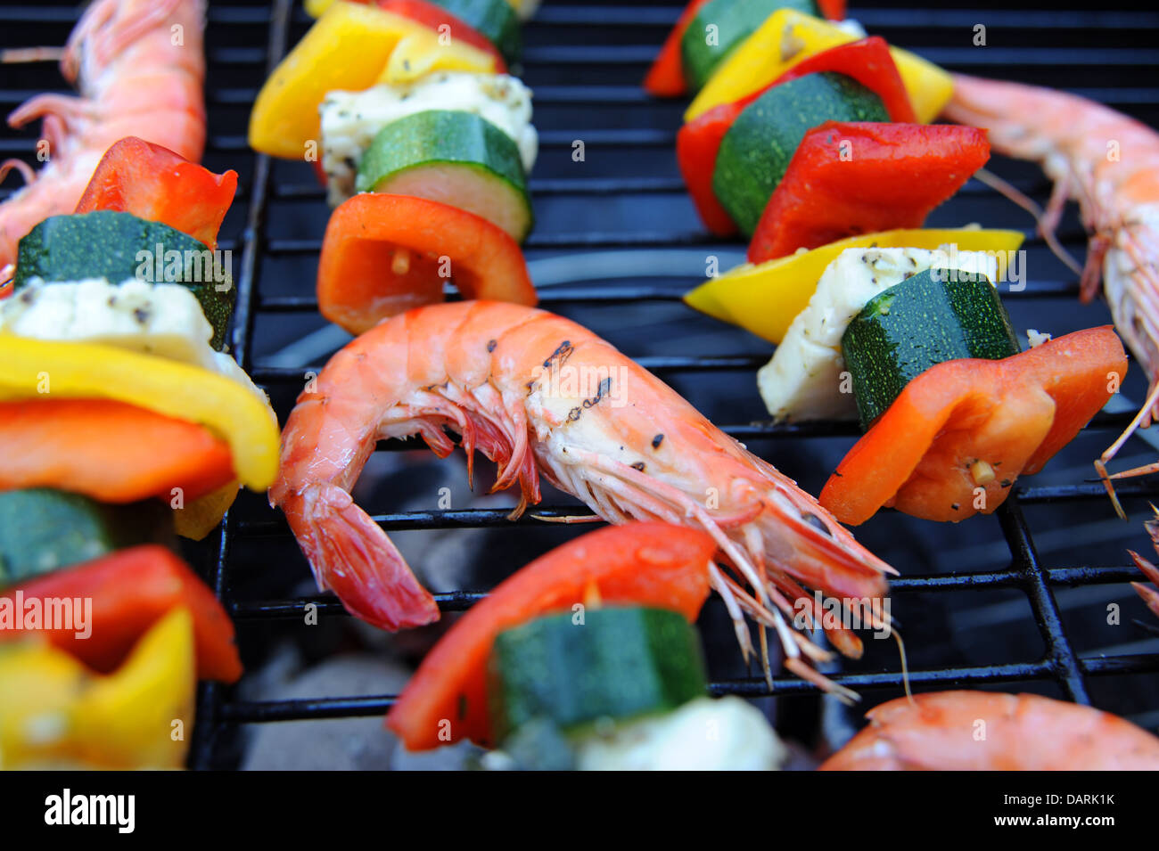 Large Madagascan prawns chargrilled cooking on a barbecue or bbq with