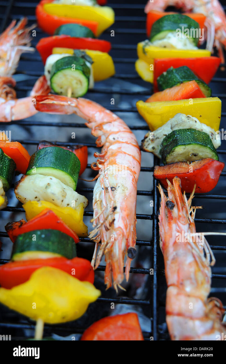 Large Madagascan prawns chargrilled cooking on a barbecue or bbq with