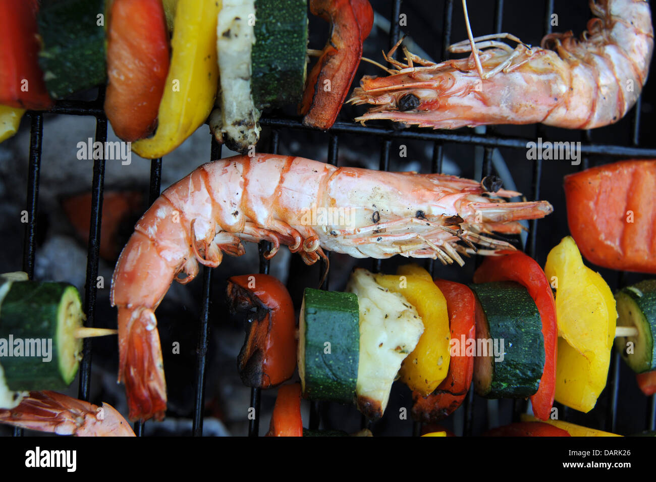 Large Madagascan prawns chargrilled cooking on a barbecue or bbq with
