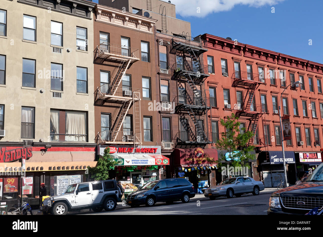 Colorful apartment buildings with fire escapes in New York City Stock Photo