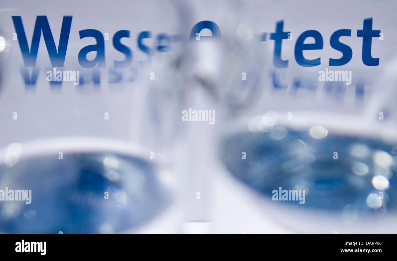 A sign reads 'Wassertest' ('Water test') behind carafes filled with ...