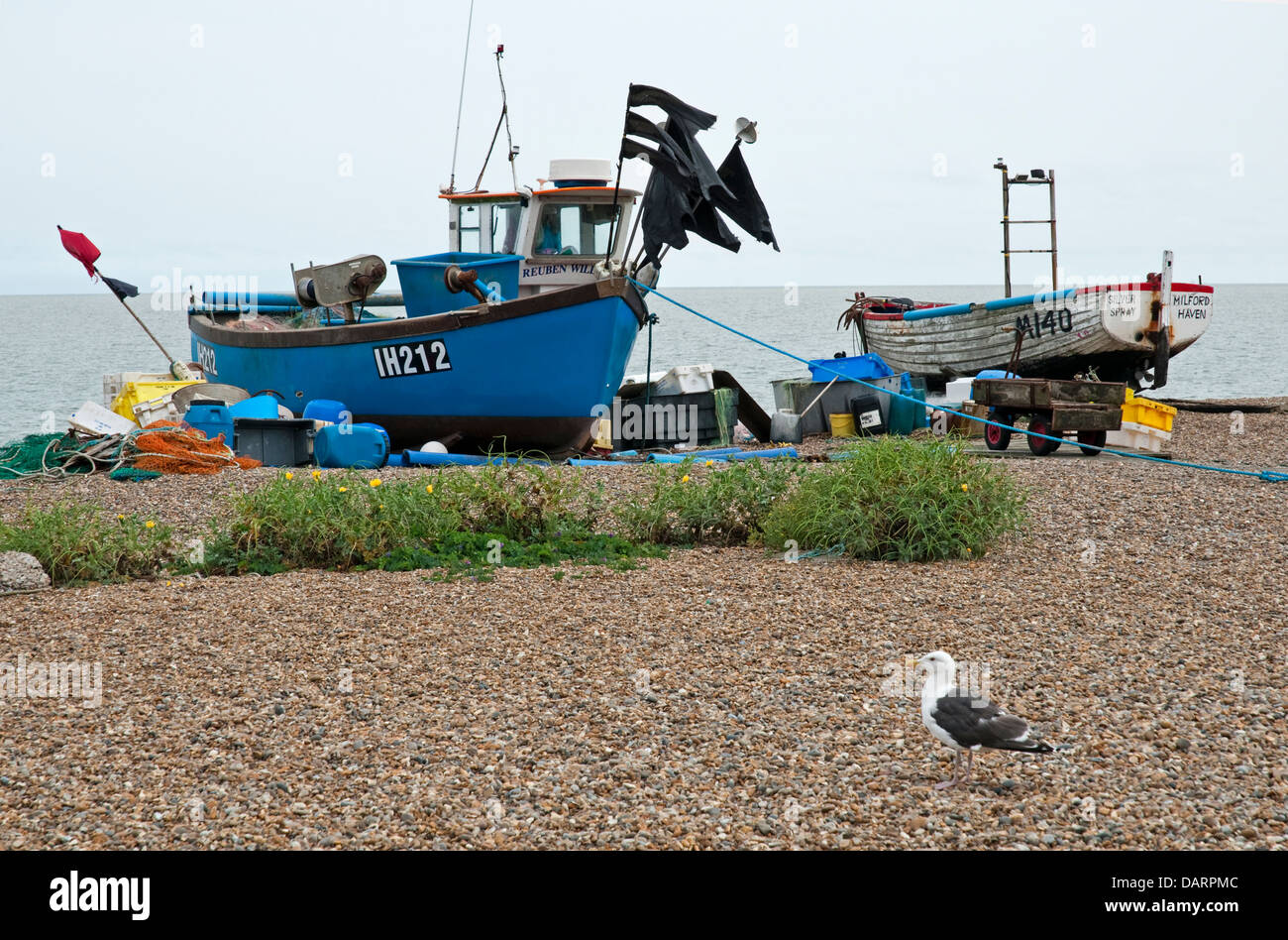 Two fishing boats moored on the seashore at low tide Stock Photo - Alamy