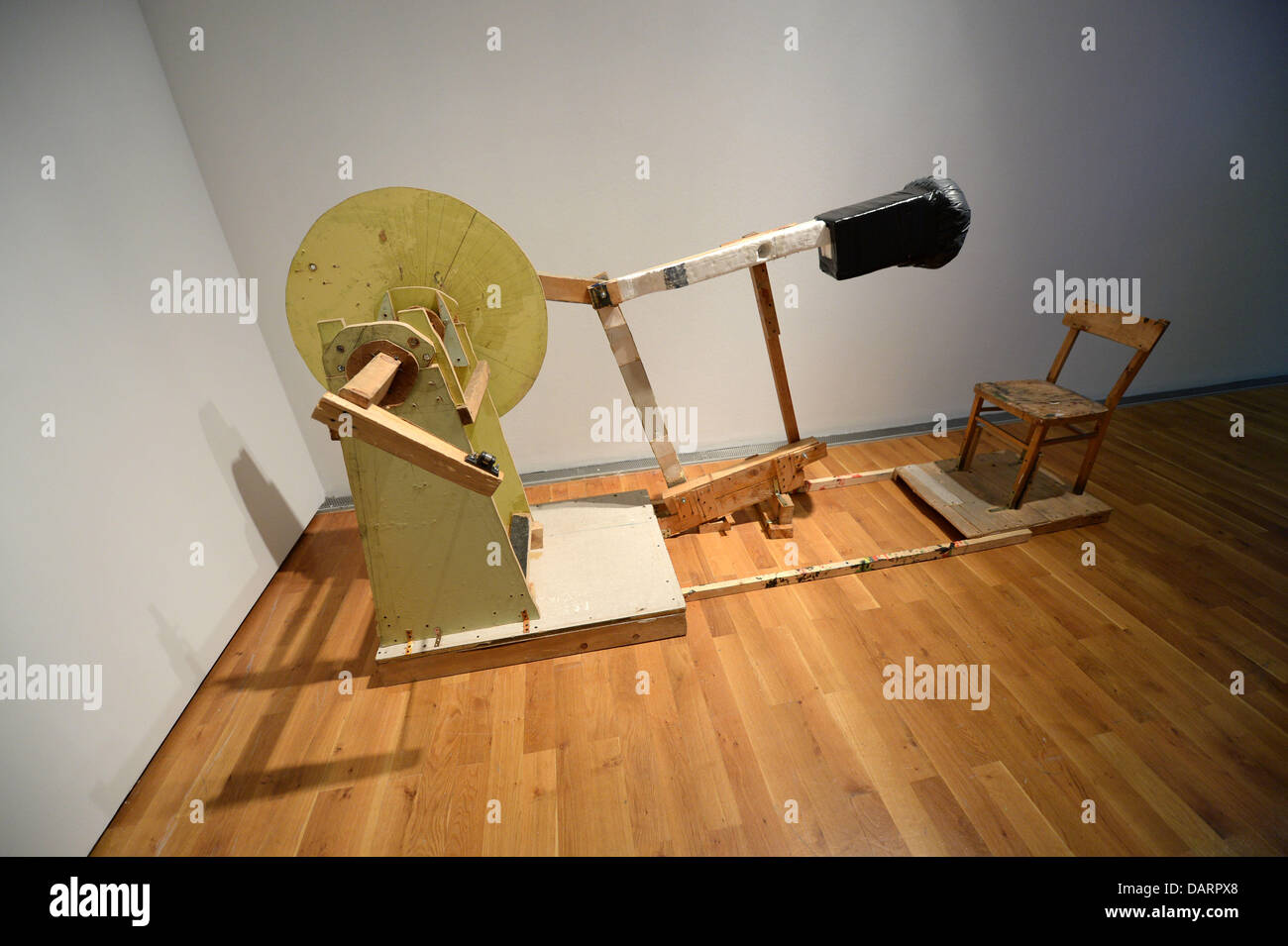 Wolfsburg, Germany. 18th July, 2013. The Nose Punch Machine by Szymon Kobylarz is shown at the exhibition 'Slapstick!' while a camera team is filming at the Kunstmuseum in Wolfsburg, Germany, 18 July 2013. In the exhibition objects, photographs, installations and films by artists such as John Bock, Rodney Graham, Wilfredo Prieto, Erwin Wurm, Fischli/Weiss, Bruce Nauman or Francis Alys are combined with scenes from movies with Charlie Chaplin, Buster Keaton, Harold Lloyd or Laurel & Hardy. Photo: PETER STEFFEN/dpa/Alamy Live News Stock Photo