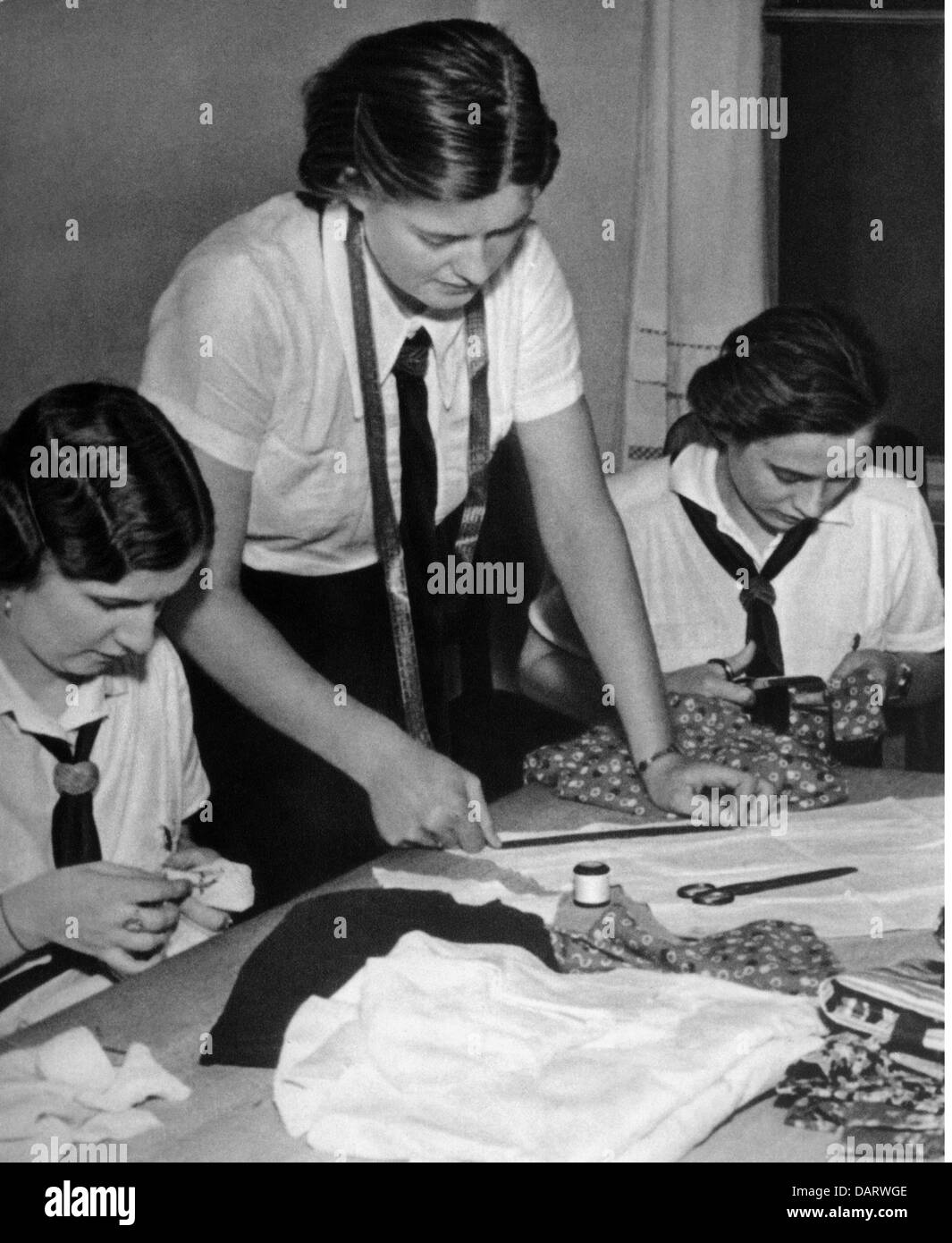 National Socialism, organisations, League of German Girls (Bund Deutscher Maedel, BDM), BDM maidens tayloring cloth, late 1930s, 30s, clothing, cutting, housework, handwork, girls, youth, people, Nazi Germany, Third Reich, 20th century, historic, historical, Madel, Mädel, people, Additional-Rights-Clearences-Not Available Stock Photo