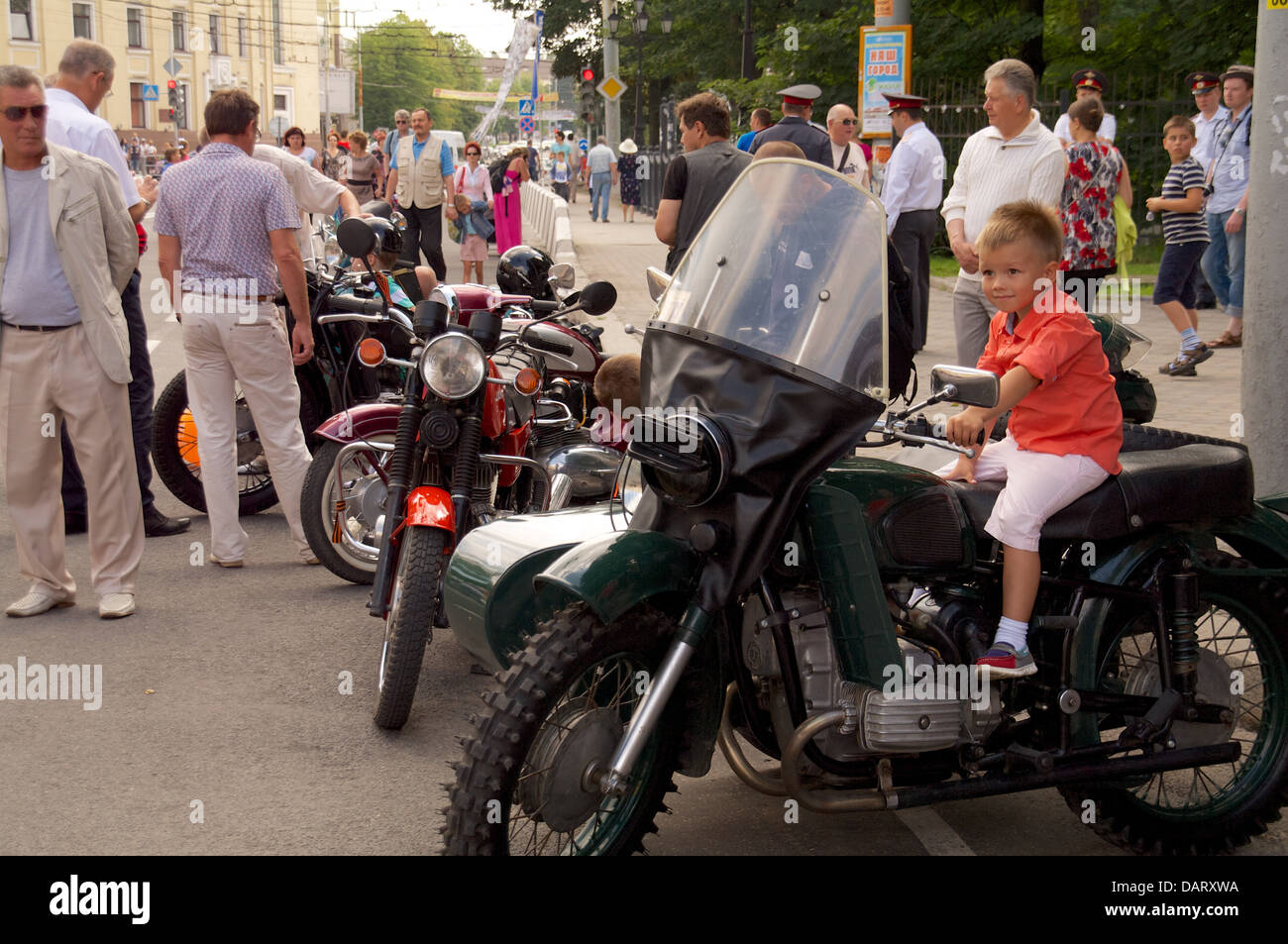 boy sit on retro bike Ural on street Stock Photo