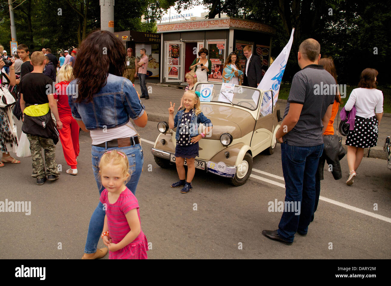girl posed near old soviet retro car on the street on City Day Kaliningrad celebration on July 14, 2013 in Kaliningrad, Russia Stock Photo