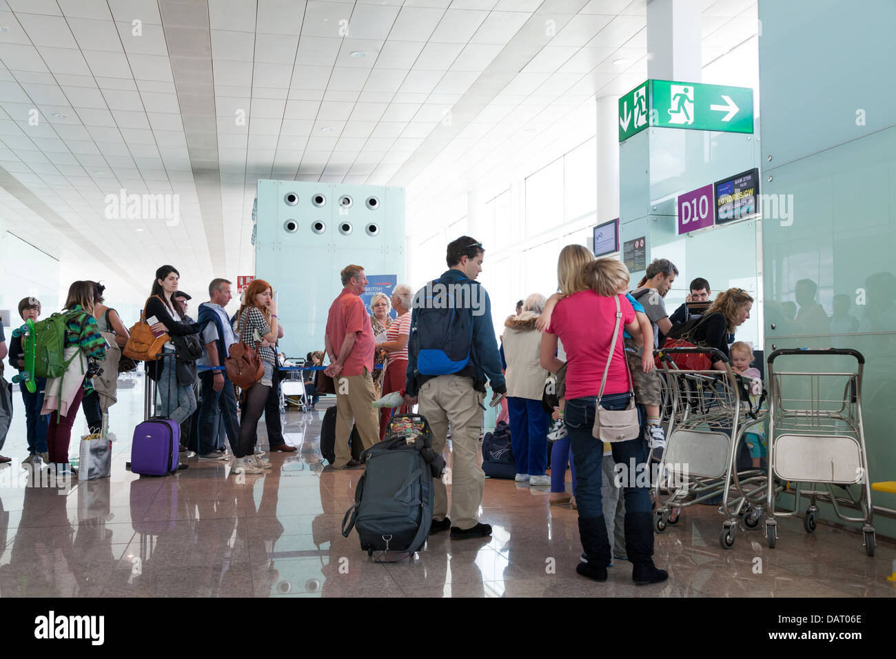 Passengers queuing to board at airport departure gate Stock Photo - Alamy
